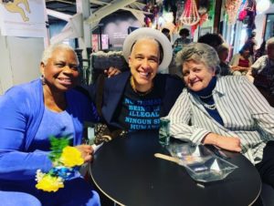 Georgia McDade, Storme Webber, and Mary Ann Moorman lean in and smile.