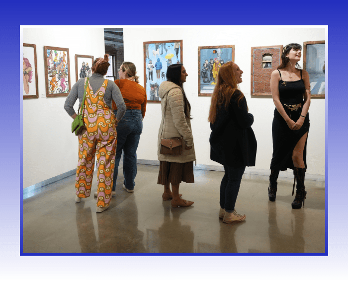 five people standing in gallery looking at art on walls