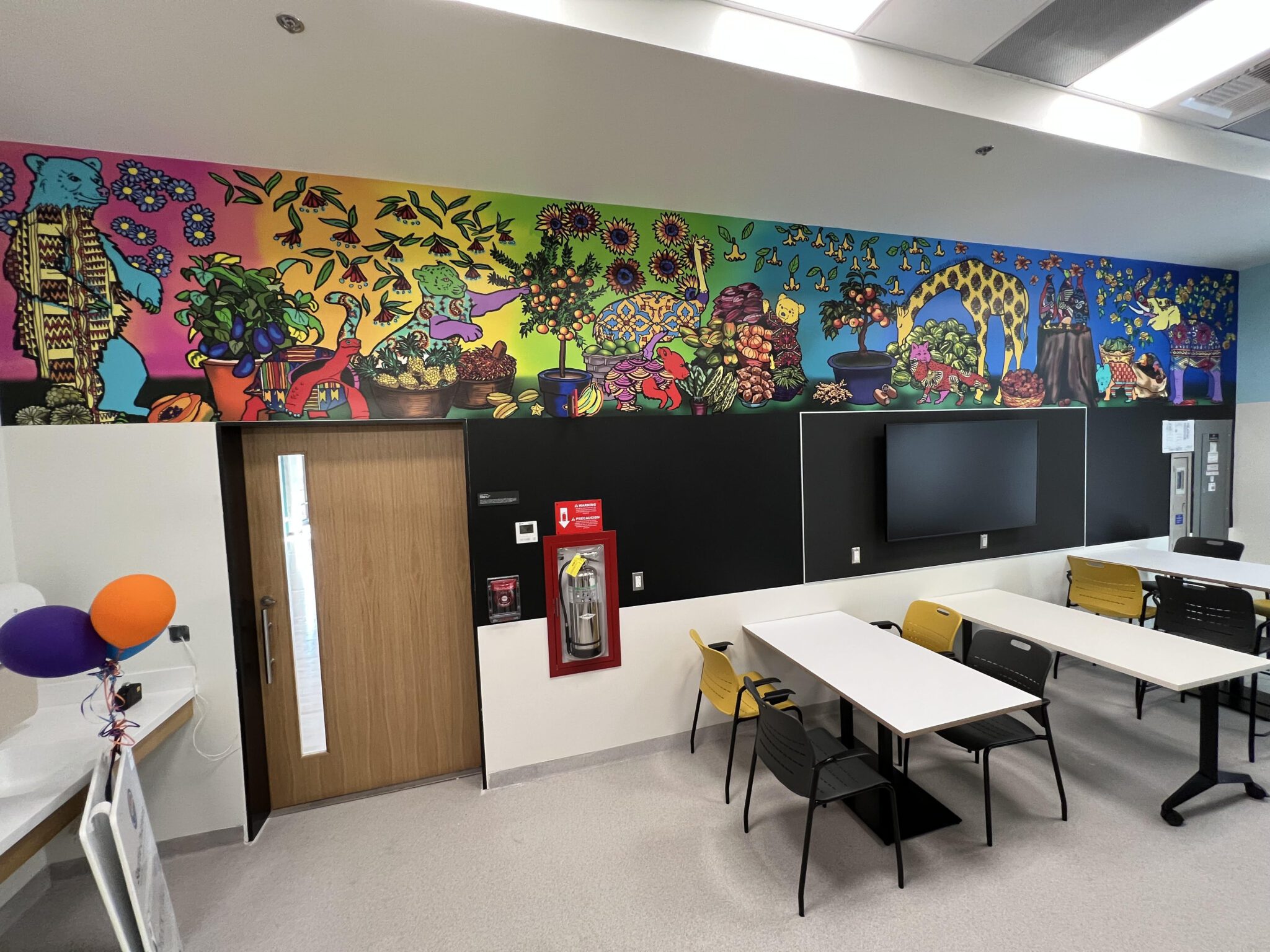 colorful painted mural along top of wall in a classroom setting