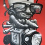 Graffiti painting of older man listening to music on headphones with arms crossed