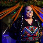 A woman in traditional Indigenous Mexican clothing smiles