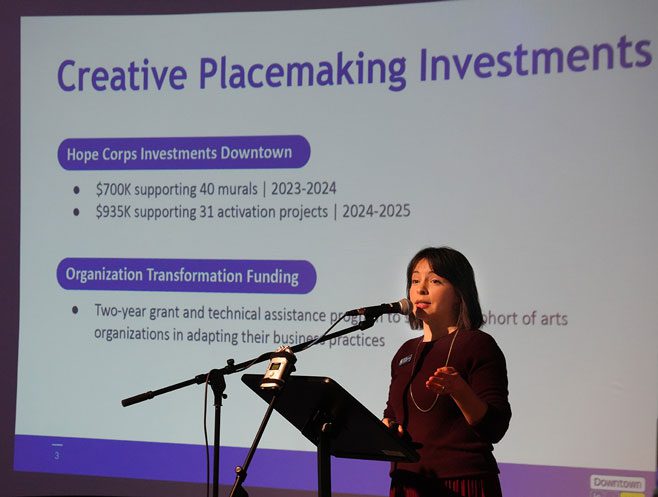 Alex speaks in front of a slide that says Creative Placemaking investments