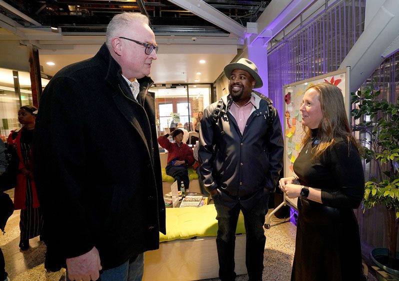 Kelly speaks to a couple of guests