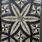 Black and white tribal patterns from Tonga form a flower shape.