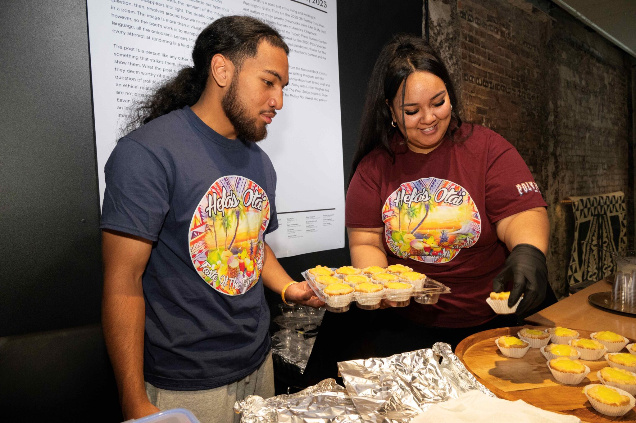 Two people set up tarts on a serving plate