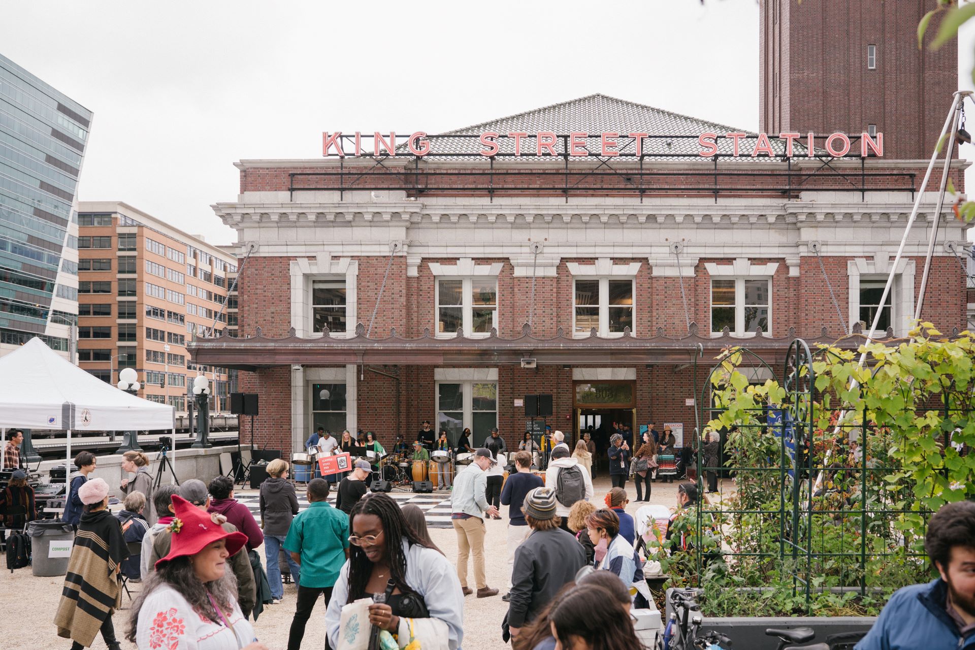 A wide shot of the King Street Station Plaza filled with visitors.