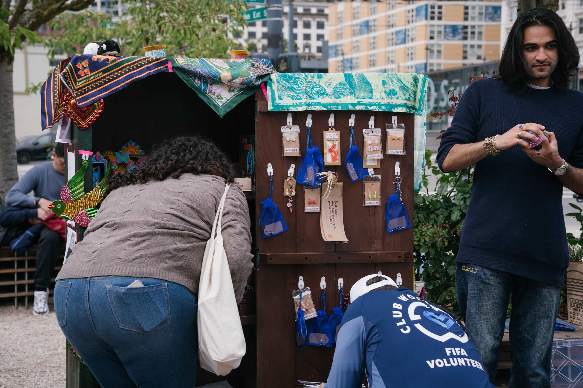 two people look into a cabinet filled with art