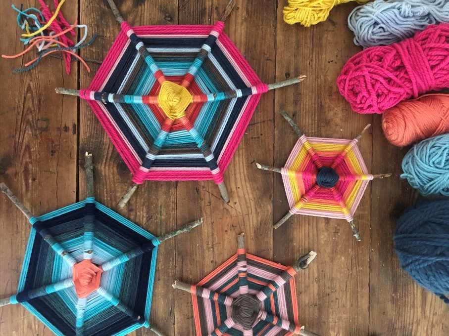 Colorful woven yarn crafts on a wood table