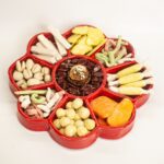 Realistic ceramic sculpture of holiday candy tray with different sweet treats