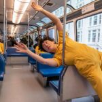 people in yellow jumpsuits dance on the Seattle monorail