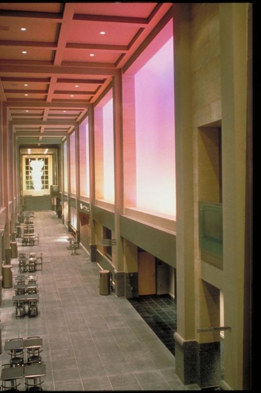 The interior of a large atrium at Benaroya Hall bathed in soft orange light.