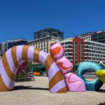 Large abstract shapes with varying patterns and color in the plaza at King Street Station.