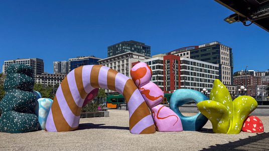Large abstract shapes with varying patterns and color in the plaza at King Street Station.