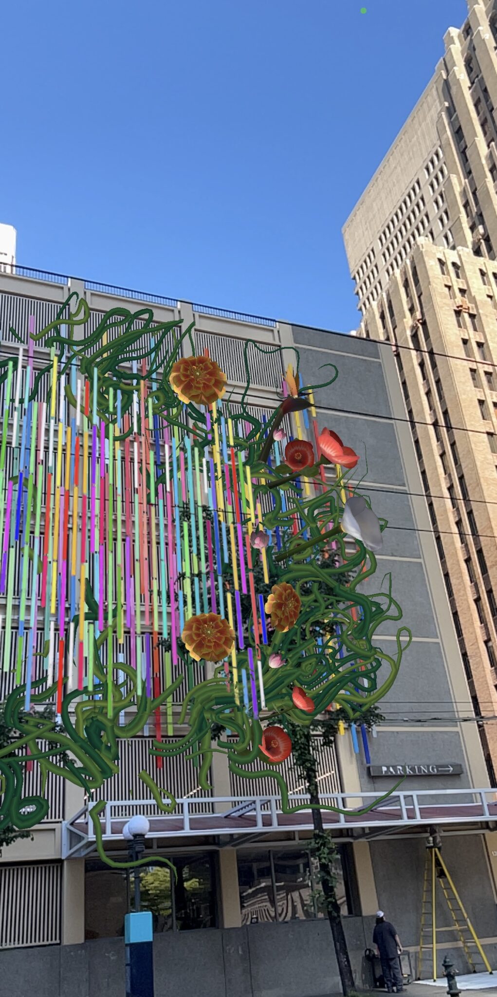 Right side of the AR interaction of Sound/s Flower Dance. It is a virtual display of various flowers and vines along the colorful bars on the building.