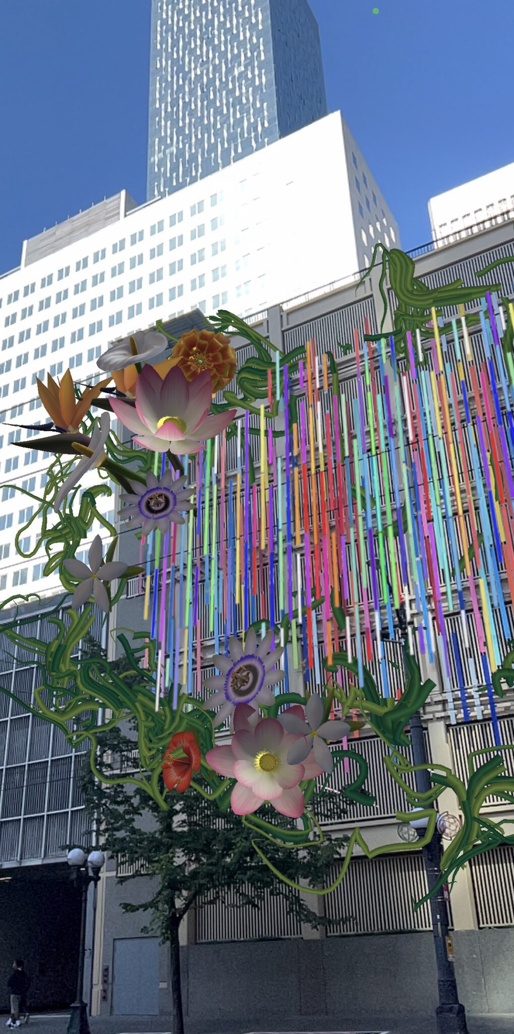 Left side of the AR interaction of Sound/s Flower Dance. It is a virtual display of various flowers and vines along the colorful bars on the building.