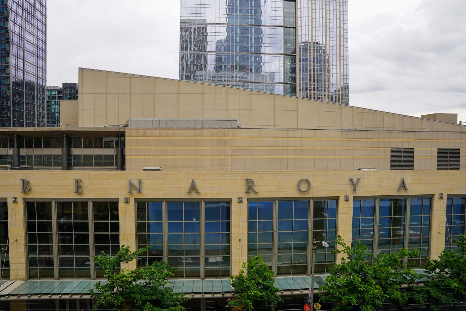The outside of Benaroya Hall, through the windows you can see the blue light of