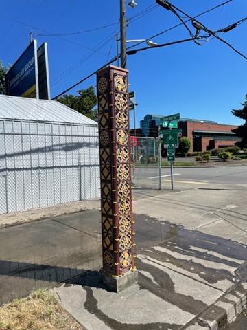 Slim brown tower after tile replacement. Two of the four panels are showing.