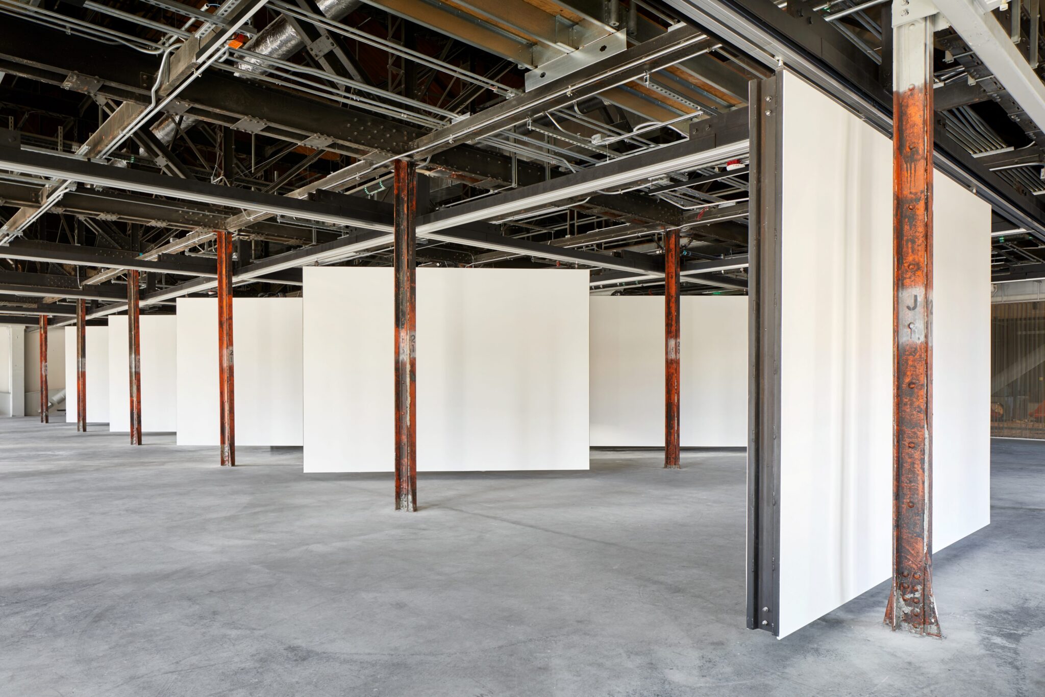 an expansive gallery space of empty white walls