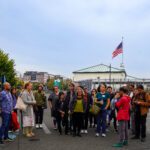 A group of artists gather on the Seattle Waterfront.